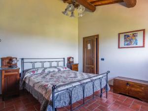 a bedroom with a bed and a wooden ceiling at Holiday Home Le Poggiole-1 by Interhome in Cavriglia