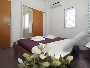 a bedroom with a bed with purple sheets and a window at Villa palm by Interhome in Protaras