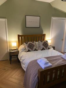 a bedroom with a bed with two pillows on it at Frasers Apartment in Golspie