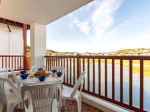 a table and chairs on a balcony with a view of the water at Apartment Ederra Untxin by Interhome in Ciboure