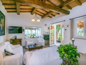 a living room with white couches and a tv at Holiday Home La Tordara by Interhome in Porto Santo Stefano