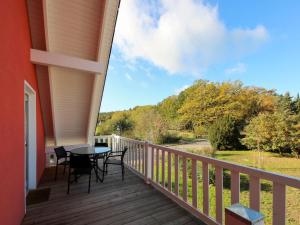 a balcony with a table and chairs on it at Apartment Müritz Ferienpark Röbel-8 by Interhome in Röbel