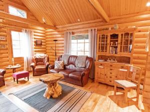 a living room with a couch and a table at Holiday Home Tievanlaita 10 by Interhome in Äkäslompolo