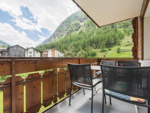 a balcony with chairs and a view of a mountain at Apartment Haus Adora by Interhome in Saas-Almagell