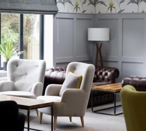 a living room with two chairs and a couch at The Kingswood in St Austell
