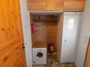 a small laundry room with a washer and dryer at Holiday Home Kätkäläinen e 2 by Interhome in Sirkka