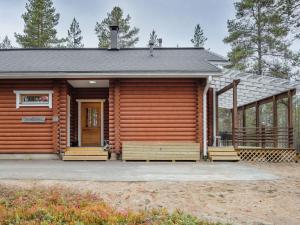 a log cabin with a porch and a door at Holiday Home Kevätruska b by Interhome in Sirkka
