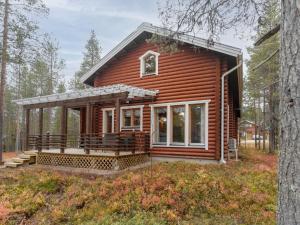 a log cabin with a porch in the woods at Holiday Home Kevätruska b by Interhome in Sirkka