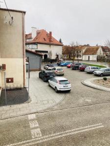 a group of cars parked in a parking lot at Mrongowiusza 3 in Olsztynek