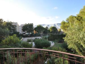 a view of a garden with mountains in the background at Apartment Porto di Mar-10 by Interhome in Cavalaire-sur-Mer
