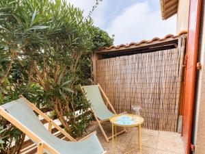 a pair of chairs and a table on a patio at Holiday Home Plage sud-3 by Interhome in Capbreton