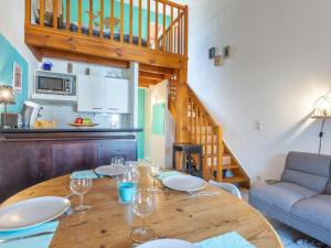 a dining room with a table with wine glasses on it at Holiday Home Plage sud-3 by Interhome in Capbreton +20 photos