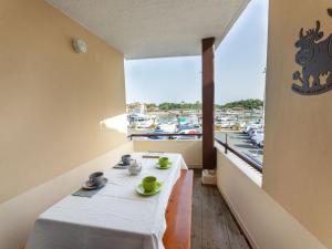 a table in a room with a view of a harbor at Apartment le Grand Foc-1 by Interhome in Capbreton
