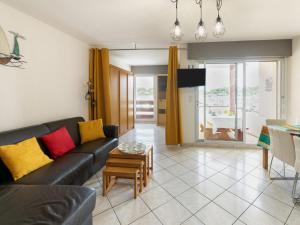 a living room with a couch and a table at Apartment le Grand Foc-1 by Interhome in Capbreton