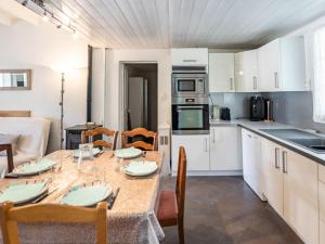 a kitchen and dining room with a table and chairs at Holiday Home Pyrénées by Interhome in Capbreton