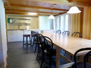 a dining room with a large wooden table and chairs at Chalet Chalet Wychel 8B by Interhome in Innertkirchen