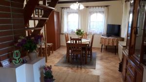 a kitchen and dining room with a table and chairs at Tulipán Ház in Bodony