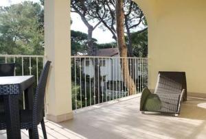 a patio with two chairs and a table and a fence at Volturnus a soli 150m dal mare con WI FI in Marina di Castagneto Carducci