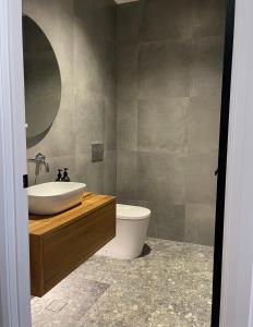 a bathroom with a sink and a toilet at Hyams Beach House A - Brand new lux beach Oasis in Hyams Beach