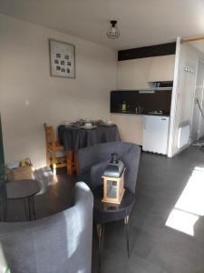 un soggiorno con tavolo e sedie e una cucina di Appartement situé en plein centre à deux pas des pistes. a Besse-et-Saint-Anastaise