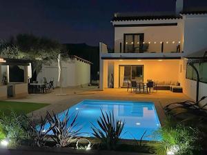 uma casa com piscina no quintal à noite em Villa Isabel by Interhome em L'Ametlla de Mar