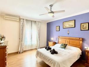 a bedroom with a bed and a blue wall at Holiday Home Villa Anita by Interhome in Rincón de la Victoria +11 photos