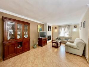 a living room with a couch and a tv at Holiday Home Villa Anita by Interhome in Rincón de la Victoria
