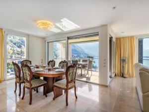 a dining room with a table and chairs at Apartment Le Belvédère D1-4 by Interhome in Montreux +33 photos