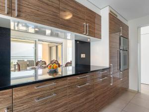 a kitchen with wooden cabinets and a window at Apartment Le Belvédère D1-4 by Interhome in Montreux