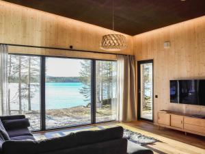 a living room with a view of the water at Holiday Home Villa livo by Interhome in Posio