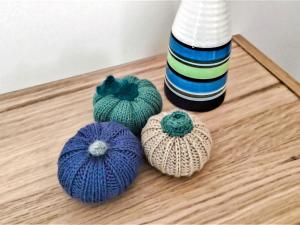 three balls of yarn sitting on a table next to a bottle at Chalet Waldoase by Interhome in Bad Arolsen