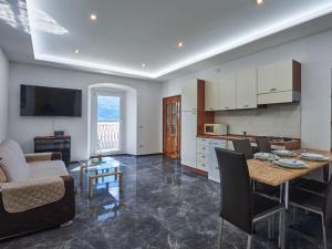 a kitchen and living room with a table and chairs at Apartment Casa Gemma by Interhome in Domaso