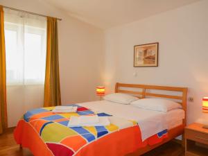 a bedroom with a bed with two towels on it at Apartment Ivana by Interhome in Senj