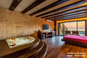 a room with a tub in the middle of a room at Manaspark Deluxe Hotel in Oludeniz