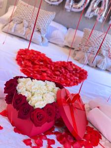 a bouquet of roses and a heart shaped cake at Bohemian Boutique Suites in Vlorë +149 photos