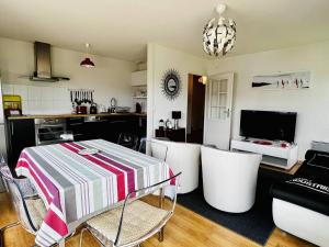 a kitchen and living room with a table and chairs at Appartement Cambo-les-Bains, 2 pièces, 2 personnes - FR-1-495-87 in Cambo-les-Bains