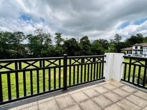 a black fence in front of a field with trees at Appartement Cambo-les-Bains, 2 pièces, 2 personnes - FR-1-495-87 in Cambo-les-Bains