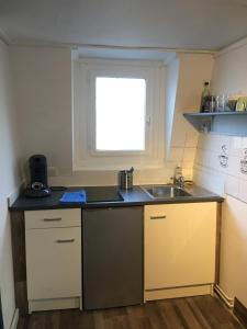 a small kitchen with a sink and a window at Studio Gambetta Republique in Lille