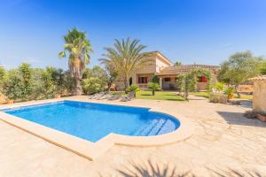 a swimming pool in the backyard of a house at Villa Can Llinàs in Sencelles