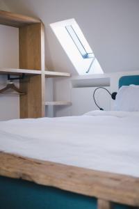 a bedroom with a bed and a skylight at The Shepherds Farm in Heuvelland