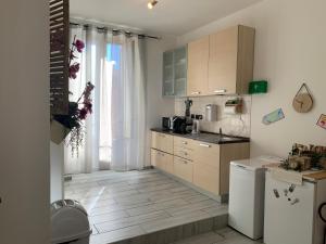 Una cocina con gabinetes de madera y un refrigerador blanco. en Julius Caesar 183, en Roma
