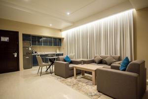 a living room with a couch and a table at Granada Palace Inn in Riyadh
