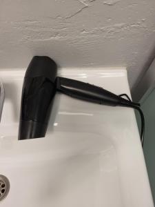 a black flashlight sitting on top of a white refrigerator at New York apartament by Karl in Radom