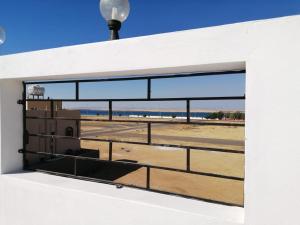 a window on a building with a view of an airport at Sharm Beach Suites Private hotel apartments in Yanbu