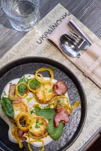 a plate of food with peppers and meat on a table at Готельна Ресторація "Україночка" in Kryvyi Rih