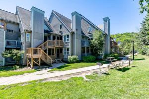 a large house with a lawn in front of it at Slope-side Studio Bliss Ski-inSki-out, Renovated At Blue, Hot Tub, Fast Wi-Fi in Blue Mountains