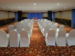 a row of white chairs in a room at Essentia Premier Hotel Chennai OMR in Chennai