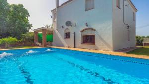 uma villa com piscina em frente a uma casa em Villa Fructus Vejer de la Frontera - El Palmar by Ruralidays em Cádiz
