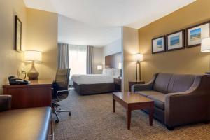 a hotel room with a bed and a couch and a desk at Comfort Suites Foley - North Gulf Shores in Foley