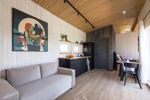 a living room with a couch and a kitchen at Pineplace in Joniškis